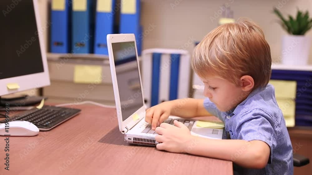 Cute little boy working on the laptop, typing something on computer, modern education in the elementary school, study with pleasure. Full HD Video 1920x1080 Cute little boy working on the laptop, typing something on computer, modern education in the elementary school, study with pleasure. Full HD Video 1920x1080