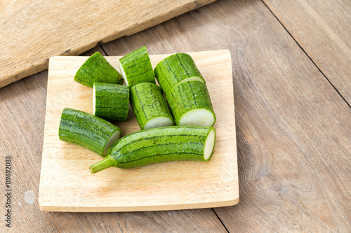 Snake gourd on wooden background photo