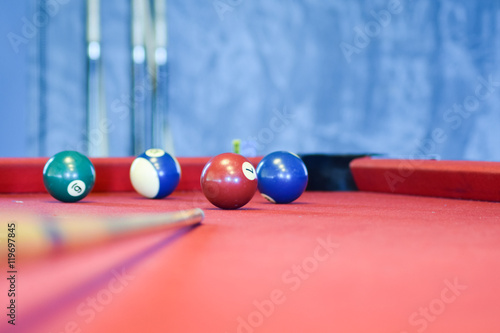 Billiard balls on a red pool table