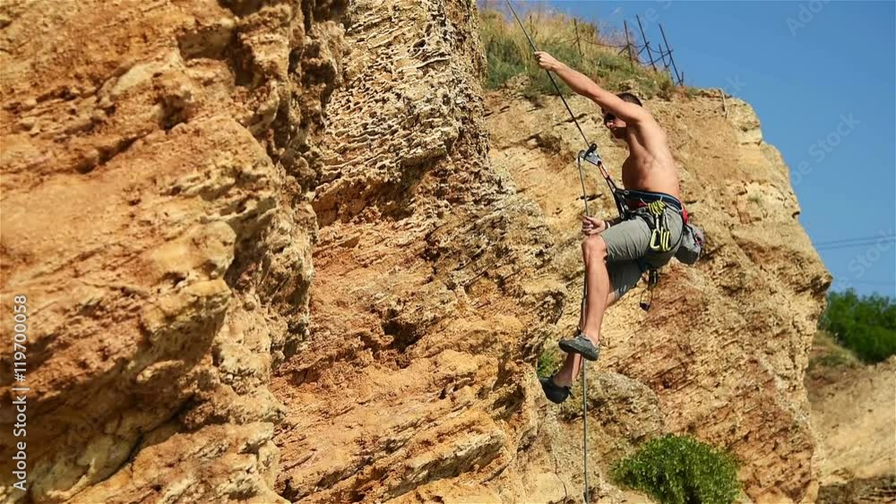 Extreme Climber Climbing A Rope From A Cliff Extreme Climber Climbing A Rope From A Cliff