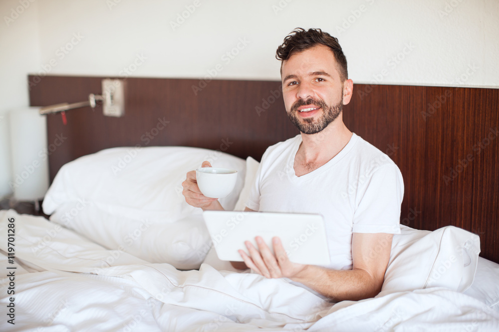 Happy man reading the news on a tablet Happy man reading the news on a tablet