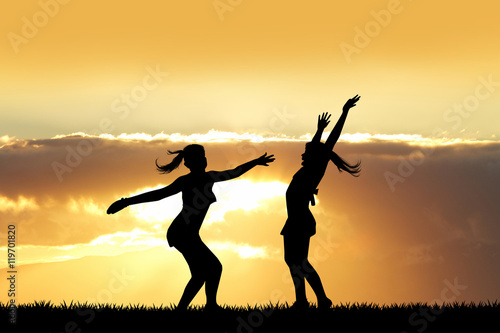 girls playing outdoors at sunset