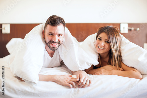 Hispanic young couple in a bed