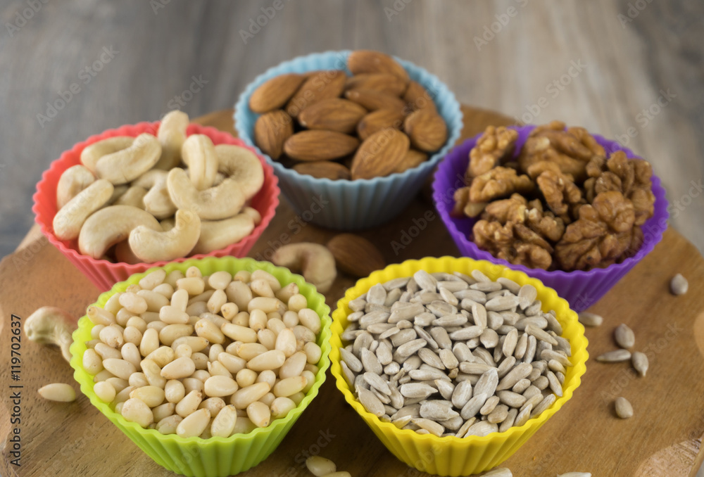 Nuts in cupcake's molds on a wooden board