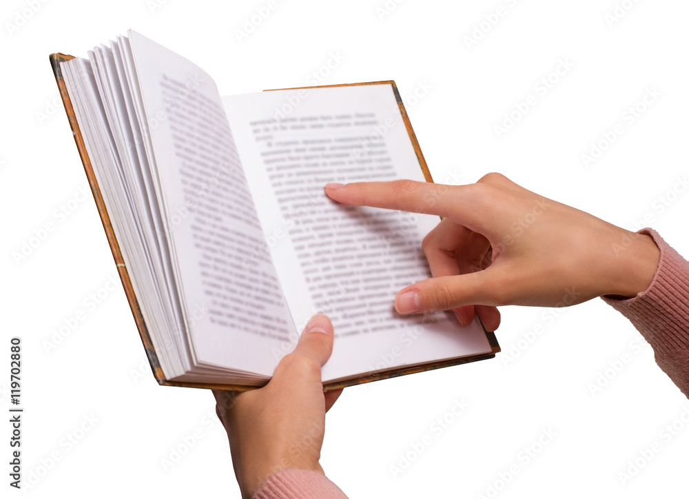 Obraz premium Isolated Female Hands holding a Vintage Book, pointing on a Word