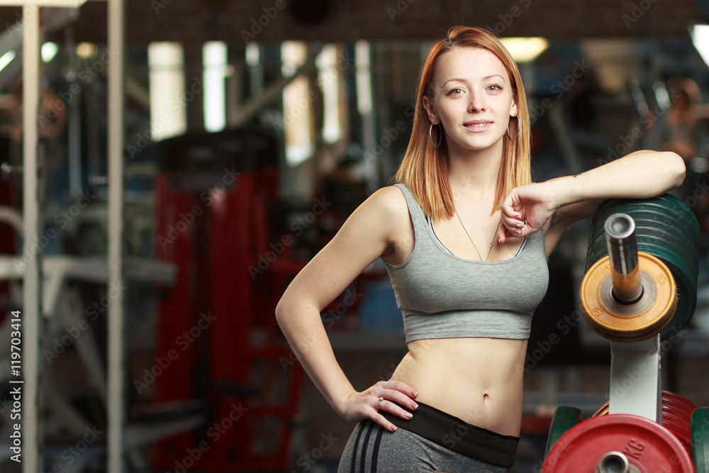 Fototapeta premium Young strong girl take breather in gym