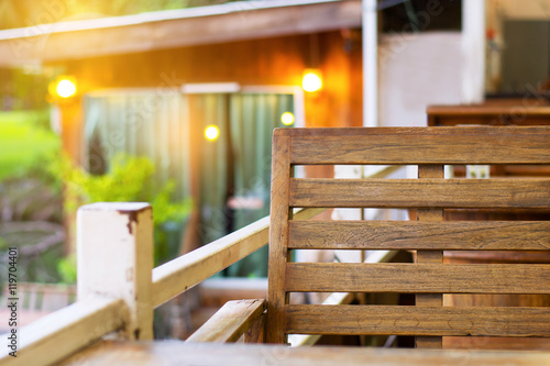 Wood chair in natural resort with sunshine and soft blur background.