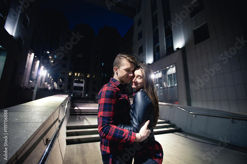 Emotional and sweet hugs among night city lights