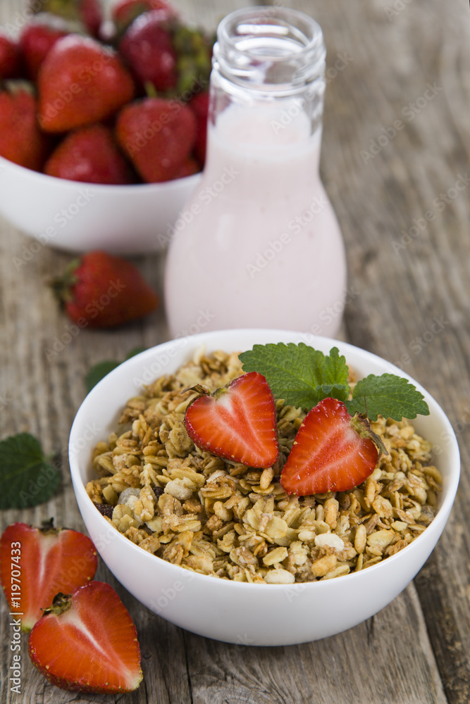Granola with strawberry on a wooden table Granola with strawberry on a wooden table