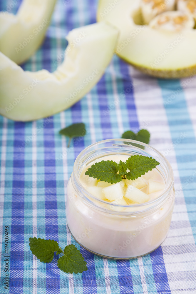 Yogurt with melon on a wooden table Yogurt with melon on a wooden table