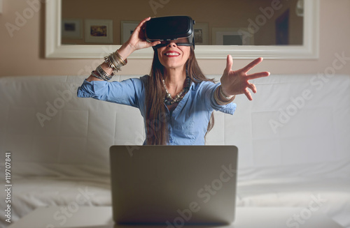 Woman experiencing virtual reality, formal clothes, photo