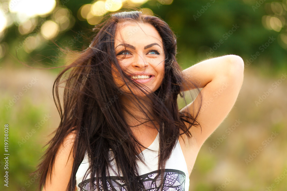 Pretty young girl walking and smiling in the park Pretty young girl walking and smiling in the park