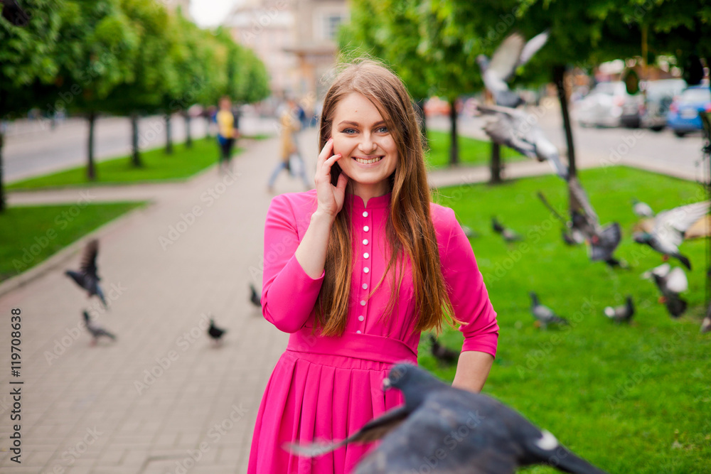 Smiling young girl in pink dress with doves Smiling young girl in pink dress with doves