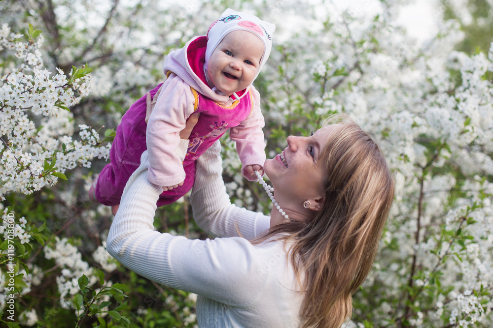mother and child in nature against the backdrop of blooming gardens mother and child in nature against the backdrop of blooming gardens