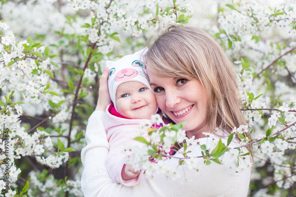 mother and child in nature against the backdrop of blooming gardens mother and child in nature against the backdrop of blooming gardens