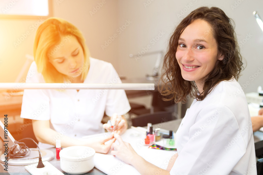 Young attractive beautician students practising during courses Young attractive beautician students practising during courses