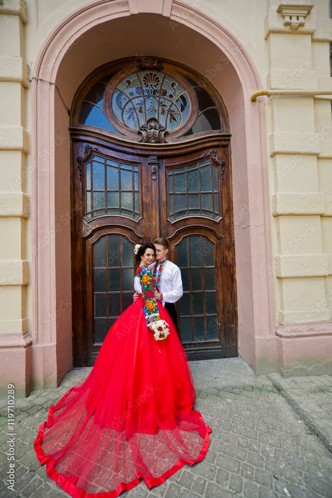Pretty bride in amazing red dress with her groom Pretty bride in amazing red dress with her groom