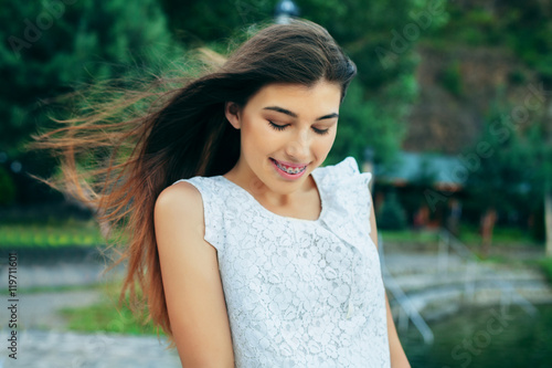 modest young beautiful girl in a white dress with long hair. The concept of lifestyle