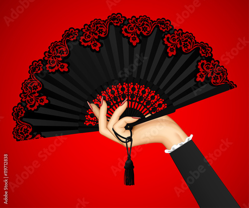 Female hand with open black vintage fan isolated on red light