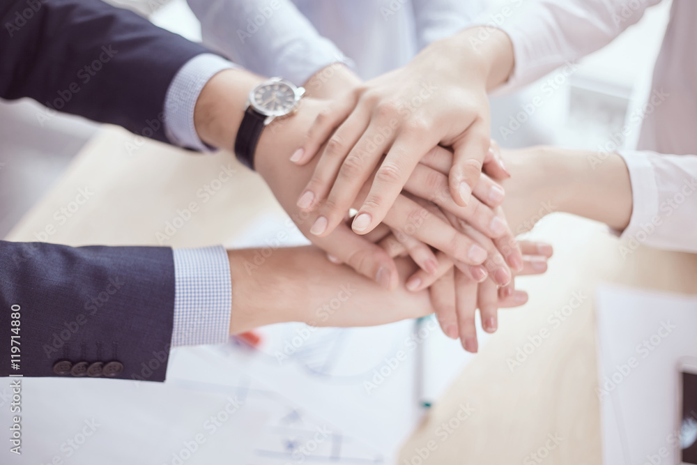 team of businessmen and businesswomen with folded hands, a symbo team of businessmen and businesswomen with folded hands, a symbo