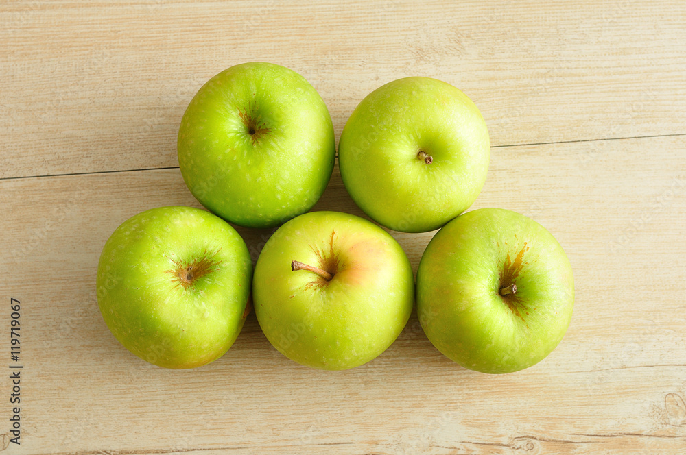 Green apples displayed on a wooden background. Top view, Green apples displayed on a wooden background. Top view,