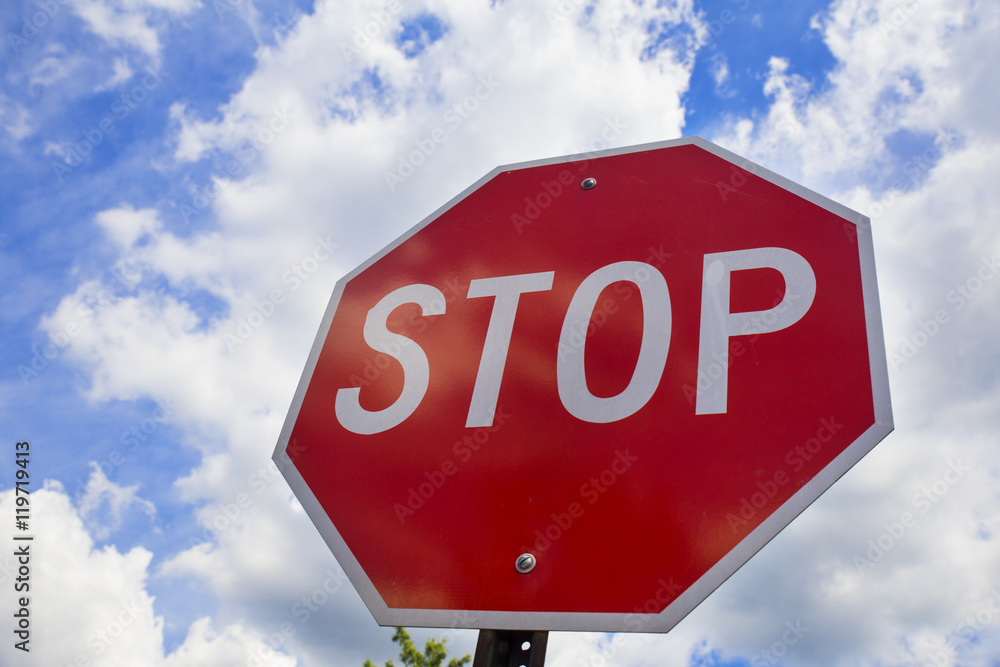 Obraz premium Red stop sign on the street, roadside traffic for stopping.