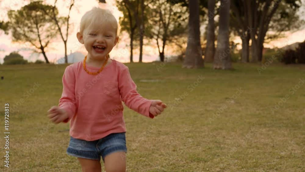 Little girl running to camera in park Little girl running to camera in park