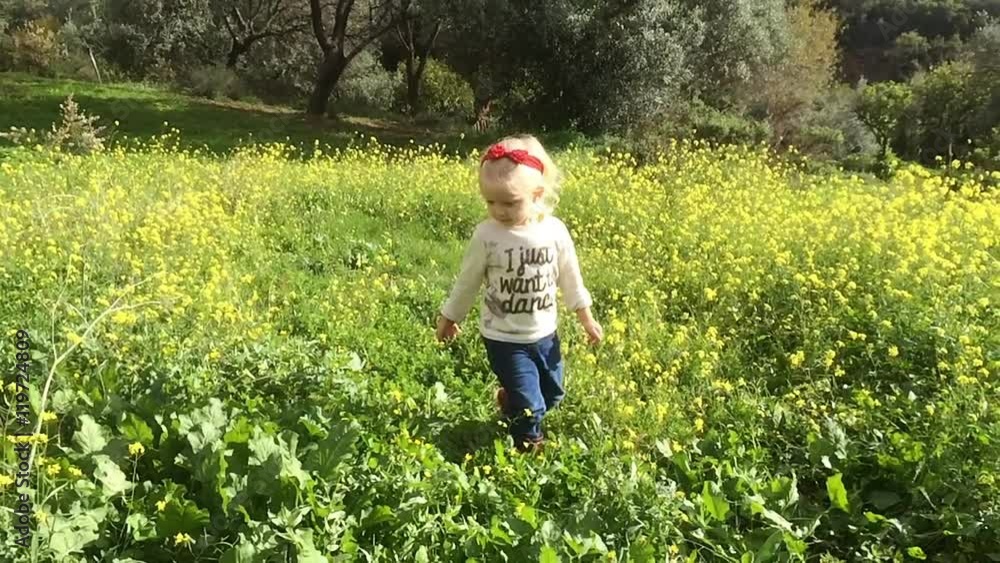 Young girl walking to camera in flower meadow Young girl walking to camera in flower meadow