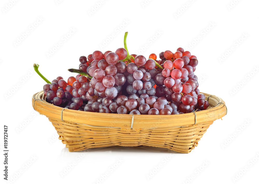 Red grapes in a basket on white background Red grapes in a basket on white background