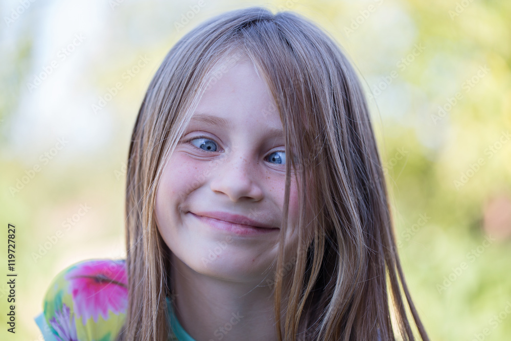 Beautiful cross-eyed young girl outdoors, portrait children close up Stock  Photo