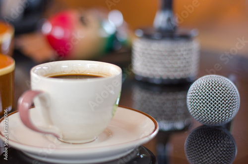 Cup of hot coffee in music  on black  background