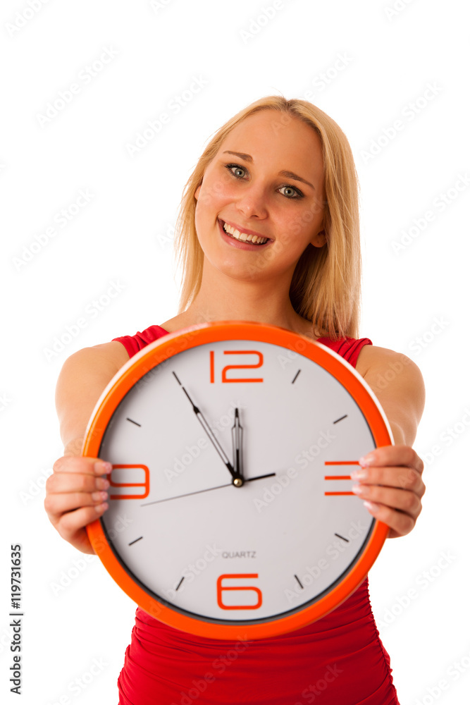Blonde business woman in red shirt holds clock as sign for time Blonde business woman in red shirt holds clock as sign for time
