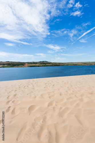 footprint on white sand dune desert and lake in Mui Ne, Vietnam