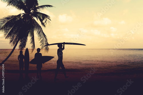Art photo styles of silhouette surfer on beach at sunset - vintage color tone