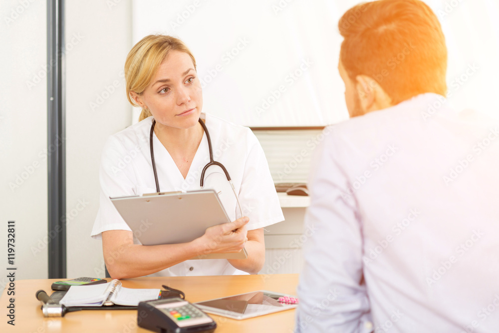 Fototapeta premium Young attractive woman doctor taking health insurance card