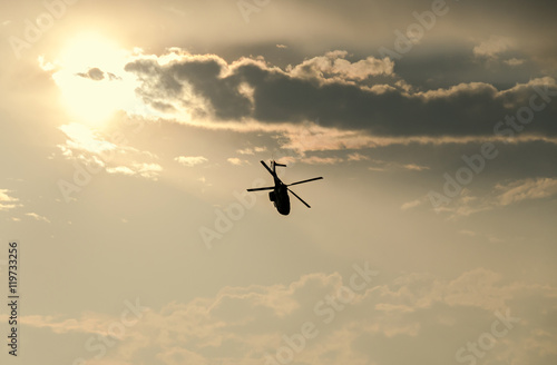 IAR Puma elicopter silhouette flying in the cloudy sky, stunt aerobic