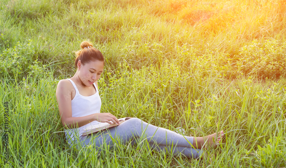 young woman standing reading book at meadows.