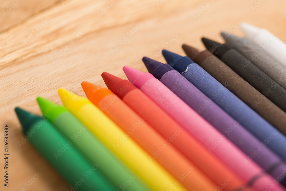 Fototapeta premium The colorful crayon on the wooden background