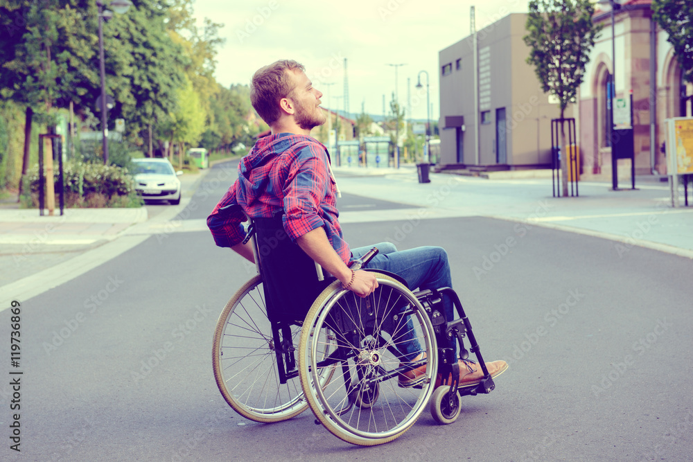 disabled man in wheelchair on road disabled man in wheelchair on road