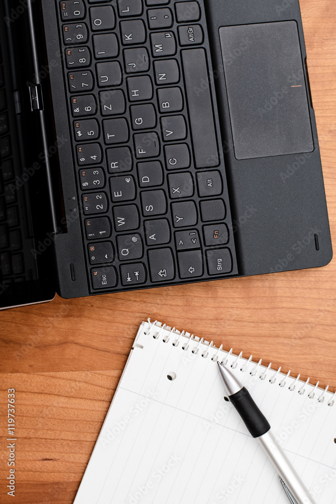 notebook and notepad on wooden table from above notebook and notepad on wooden table from above
