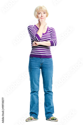 Dreaming lady. Thoughtful middle aged woman holding hand on chin and looking at camera while standing isolated on white background.