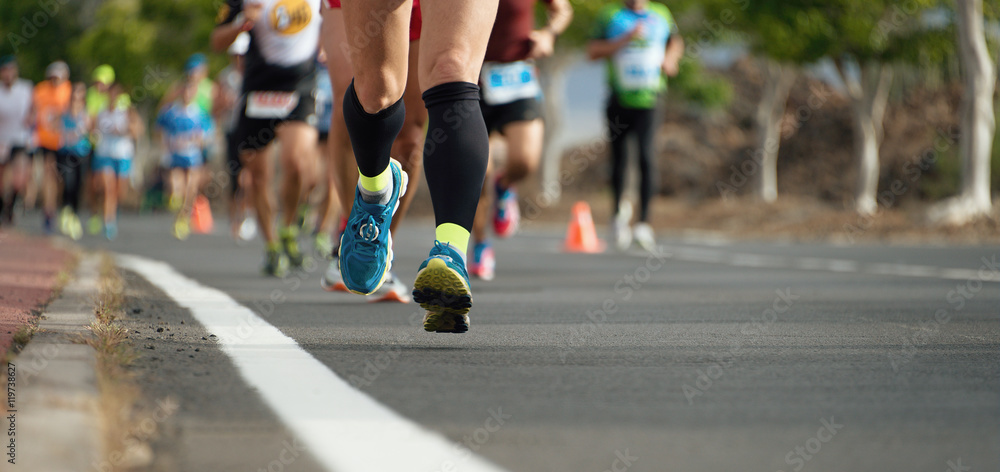 Marathon running race, people feet on city road Marathon running race, people feet on city road