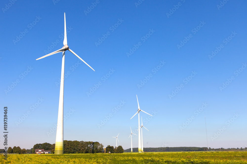 Wind turbine spinning with in a green countryside environment Wind turbine spinning with in a green countryside environment