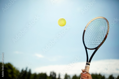 Close up of tennis racket and ball