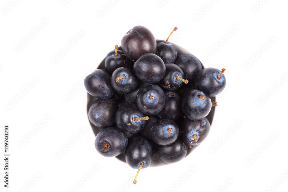 black plum in a dish isolated on a white background