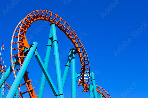 Orange rollercoaster with blue sky in the background