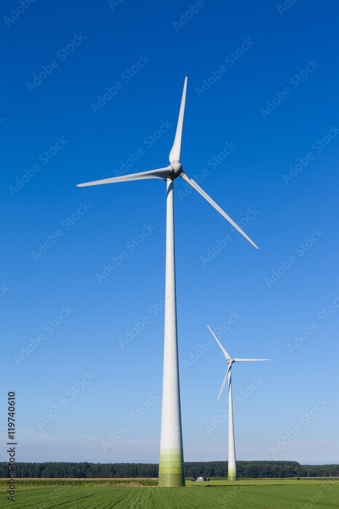 Wind turbine spinning with in a green countryside environment Wind turbine spinning with in a green countryside environment