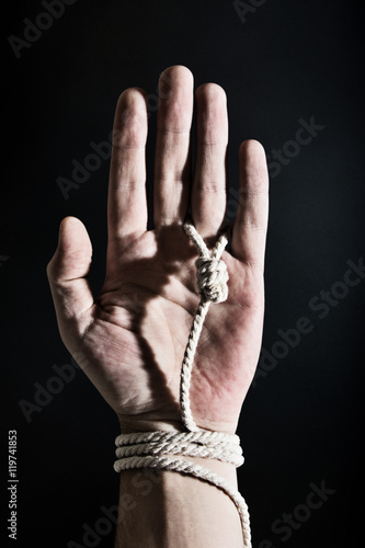 Hand with hangman noose around ring finger