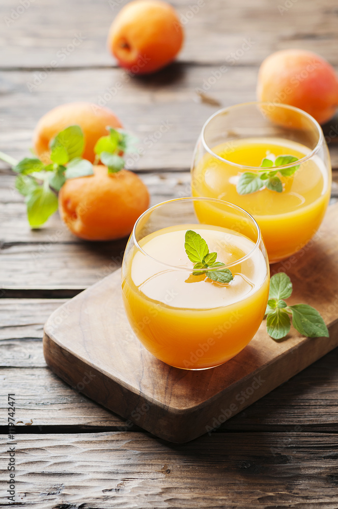 Healthy apricot juice with mint on the wooden table Healthy apricot juice with mint on the wooden table