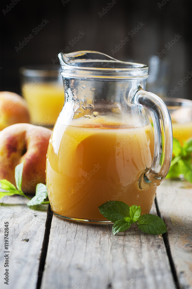 Fresh peach juice with mint on the wooden table Fresh peach juice with mint on the wooden table